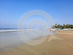 Turquoise water and white sand in beautiful Colva beach, clean water Arabian sea beach, goa beach, tropical beach.