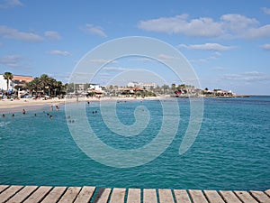 Turquoise waters of Atlantic Ocean landscape and pier at african town of Santa Maria on Sal island in Cape Verde