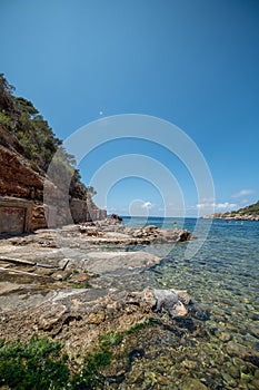 Turquoise waters of Cala Salada in Ibiza in summer photo