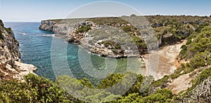 Turquoise waters in Mallorca. Bota cove. Panoramic mediterranean coastline. Balearic