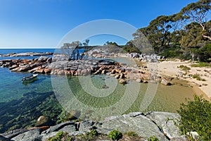 Turquoise waters rippled, lichen growing on granite rocks, rocky