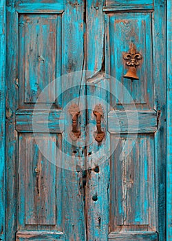 Turquoise wooden door with peeling paint photo