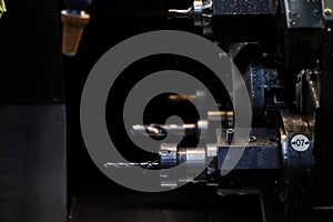 turret head in black for setting various drill bits.The hi-technology metal working process by CNC turning machine