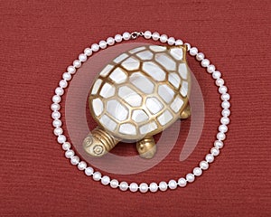 Turtle jewelry box and pearl necklace