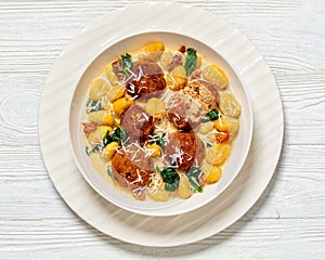 tuscan chicken meatballs with gnocchi in a bowl