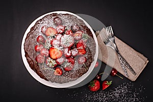 Tuscan chocolate cake with strawberries and cherries