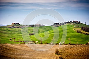 Tuscan hill with row of cypress trees and farmhouse. Tuscan landscape. Italy