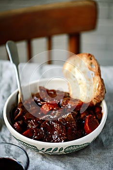 Tuscan style beef stew with toasted bread. style vintage