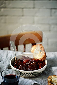 Tuscan style beef stew with toasted bread. style vintage