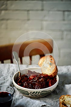 Tuscan style beef stew with toasted bread. style vintage