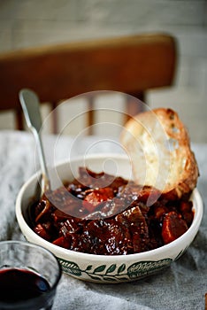 Tuscan style beef stew with toasted bread. style vintage