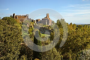 Tuscania, Viterbo, Lazio, Italy: landscape of the countryside with the ruins of the ancient city walls and the medieval Saint