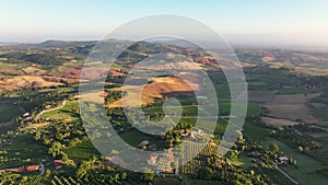 Tuscany aerial view, flying over vineyards, olive fields, and traditional houses