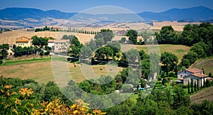 Tuscany, Italy scenic landscape- with haybales and cypress lined driveway