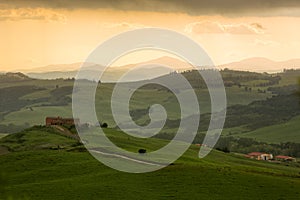 Tuscany landscape with farmhouse and yellow sky, Pienza, Italy