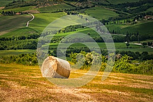 Tuscany landscape with hay bales in the field, Italy