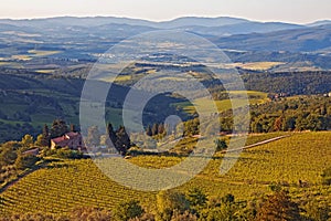 Tuscany landscape with rolling hills and valleys in sunset light