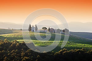 Tuscany landscape at sunrise with a little chapel of Madonna di Vitaleta, Italy.