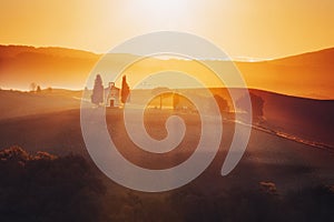 Tuscany landscape at sunrise with a little chapel of Madonna di