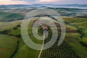 Tuscany rural landscape, foggy morning landscape with green rolling hills of countryside farm in Val d\'Orcia, Italy