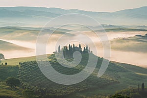 Tuscany rural landscape, foggy morning landscape with green rolling hills of countryside farm in Val d\'Orcia, Italy