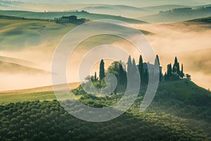 Tuscany rural landscape, foggy morning landscape with green rolling hills of countryside farm in Val d\'Orcia, Italy
