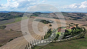 Tuscany rural landscape with house, cypress road and hills. Aerial view.