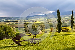 Tuscany rural landscape with old plow in the foreground. Toscana in the morning, Italy.