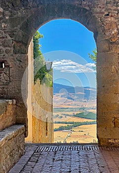 Tuscany seen through archway in Pienza