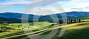 Tuscany spring, rolling hills on spring . Rural landscape. Green fields and farmlands. Italy, Europe
