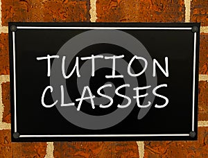 Tution classes sign on a  board.