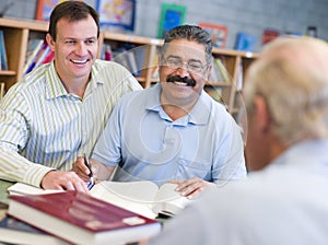 Tutor assisting mature student in library