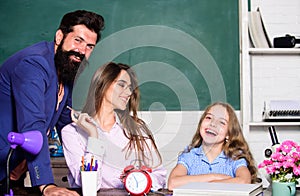 Tutor for excellence. Extra classes. Gifted child. Little girl studying with team of tutors. Home tutoring concept photo
