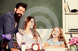 Tutor for excellence. Extra classes. Gifted child. Little girl studying with team of tutors. Home tutoring concept photo