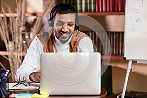 Tutor Man Having Class Via Video Call On Laptop Indoors