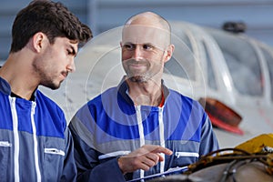 Tutor and student in aircraft hangar