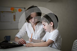 Tutor teach preschooler with laptop, real home