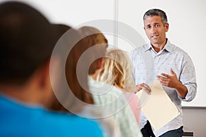 Tutor teaching class of students