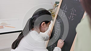 In tutorial school, Asian students learn to write in both English and Chinese