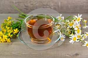 tutsan and camomile herbal tea in glass cup