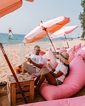 Tutu beach Pattaya Thailand, couple relax on the beach, men and woman on retro beach setting in Jomtien