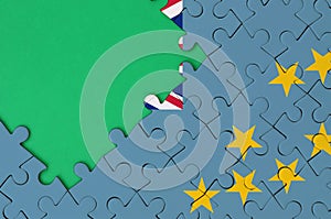 Tuvalu flag is depicted on a completed jigsaw puzzle with free green copy space on the left side
