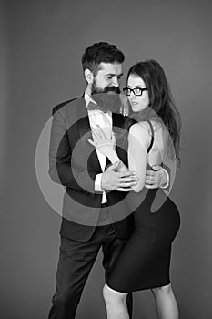 Tuxedo and dress. Formal couple. art experts of bearded man and woman. esthete. Romantic relationship. Couple in love on