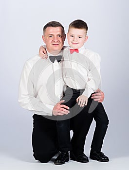 Tuxedo style. happy child with father. business meeting party. little boy with dad businessman. family day. esthete