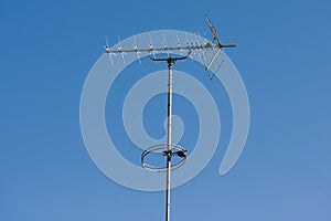 TV aerial with blue sky background