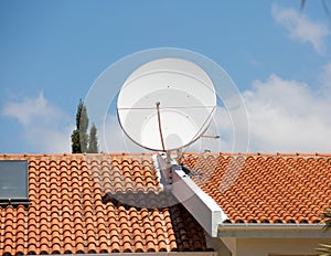 Tv antenna on the red tile roof