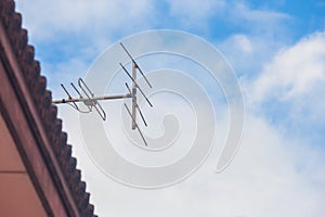 TV antenna on roof of house.