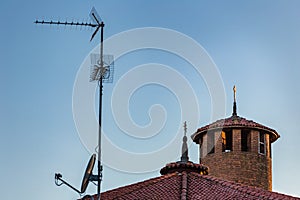 TV antenna, satellite dish and Catholics Cross photo