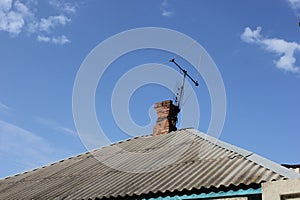 TV antenna tied to the red brick chimney