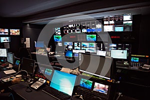 TV Broadcast news studio with many computer screens and control panels for live air broadcast.